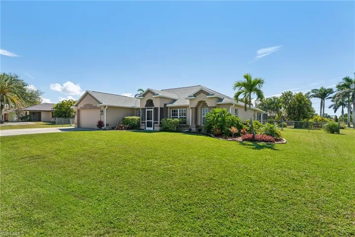 Ranch-style home with driveway, stucco siding, and an attached garage