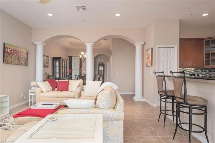 Living room with a notable chandelier and light tile patterned floors