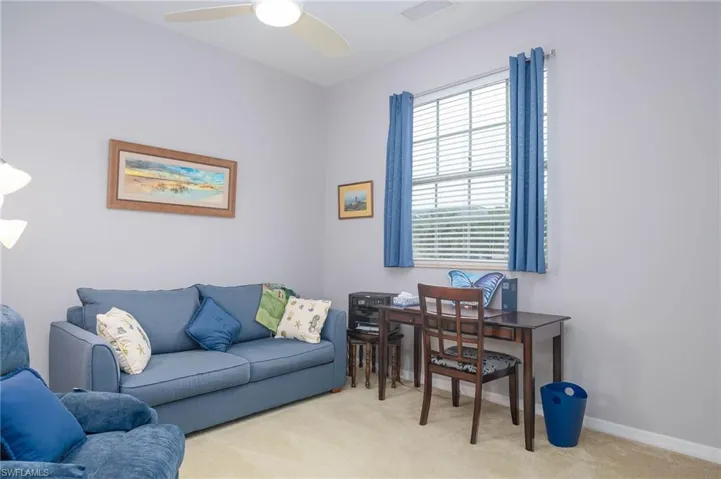 Office area featuring ceiling fan and light colored carpet