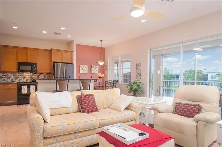 Living room with light tile patterned floors and ceiling fan
