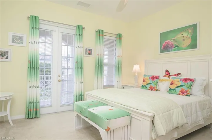 Carpeted bedroom with multiple windows, access to outside, and ceiling fan