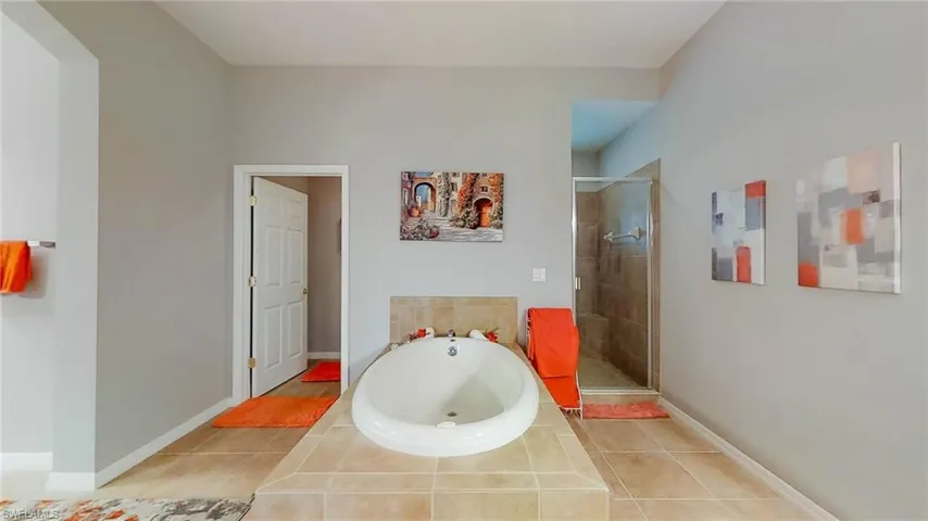 Bathroom with tile patterned flooring and independent shower and bath