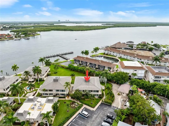Birds eye view of property with a water view