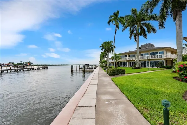 Dock area featuring a water view and a yard