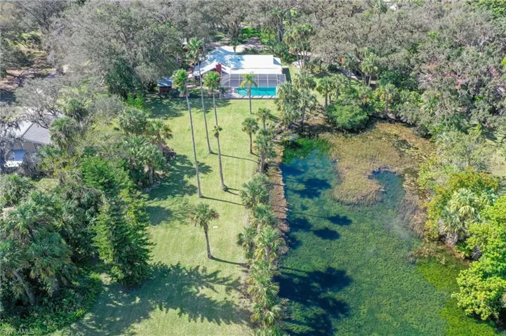 Aerial view of property, Back of house, pond, and surrounding area