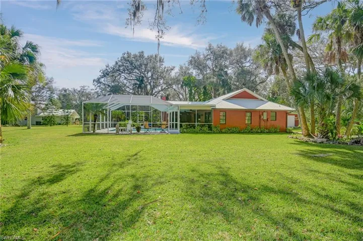 Back of property with lanai and pool