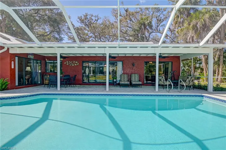 Swimming pool featuring a patio, a lanai, and outdoor dining area