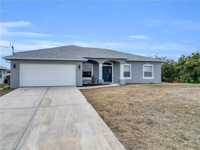 Ranch-style home featuring stucco siding, concrete driveway, and a garage