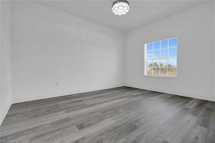 Empty room with light wood finished floors