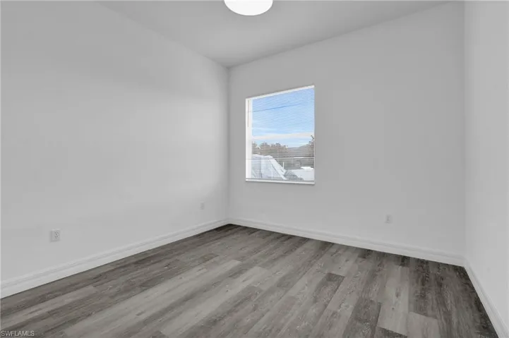 Spare room with wood finished floors and baseboards
