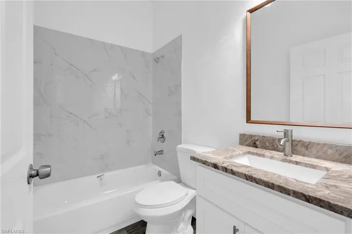Bathroom with vanity and bathtub / shower combination