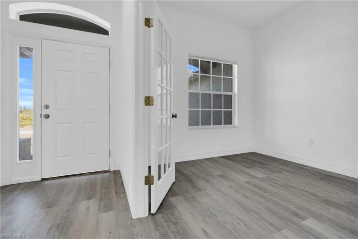 Entryway featuring wood finished floors and baseboards