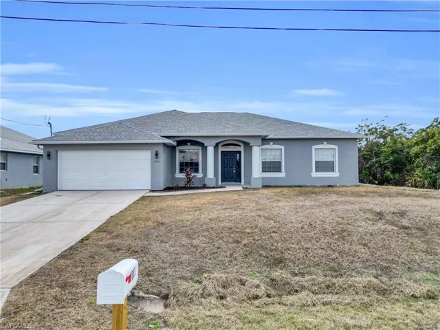 Ranch-style house with stucco siding, roof with shingles, a garage, and concrete driveway