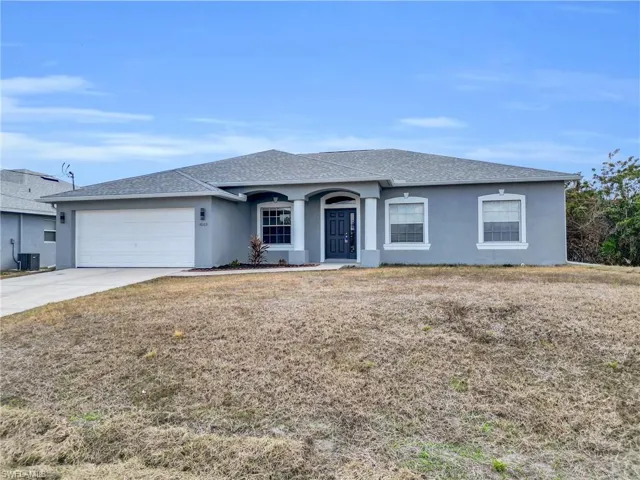 Ranch-style home with stucco siding, a shingled roof, and an attached garage