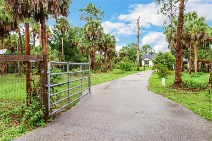 View of home's community with a lawn