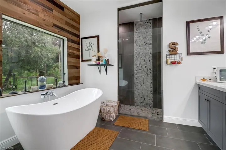 Bathroom with plus walk in shower, vanity, and tile patterned floors