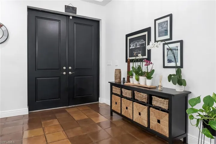 Foyer entrance featuring dark tile patterned floors