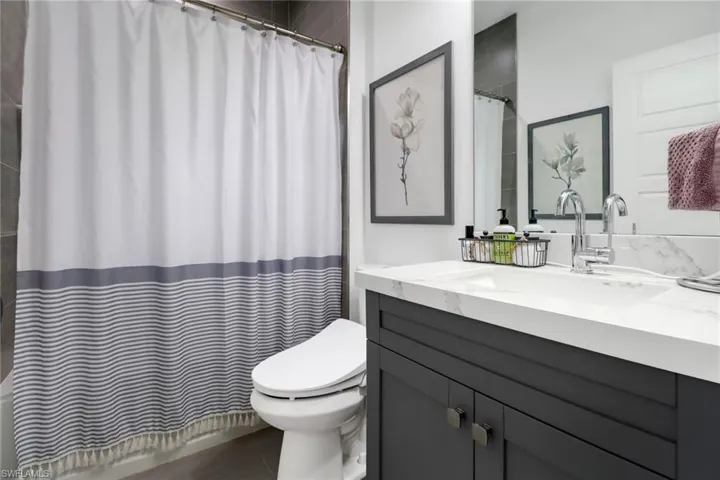 Bathroom with tile patterned floors, vanity, and toilet