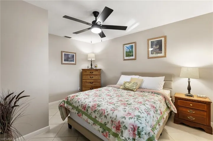 Bedroom featuring light tile patterned floors and ceiling fan