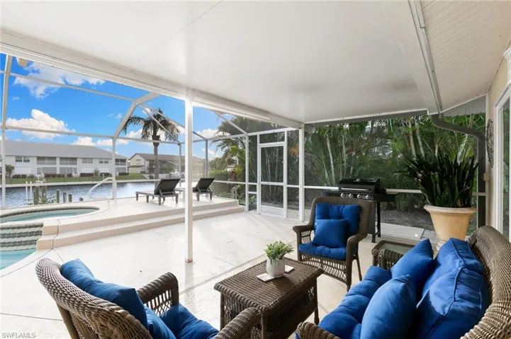 Sunroom / solarium featuring a hot tub, a patio area, a water view, an outdoor hangout area, and plenty of natural light