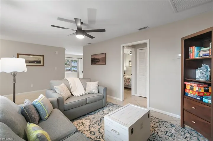 Living room featuring light tile patterned floors and baseboards