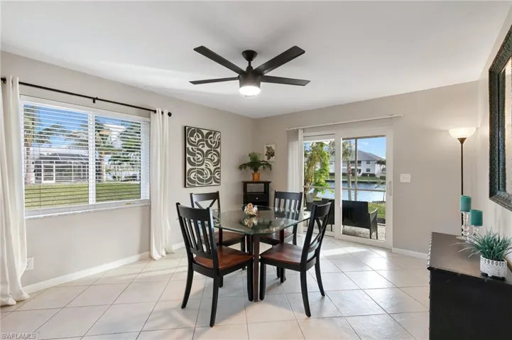 Dining area featuring light tile patterned flooring and ceiling fan