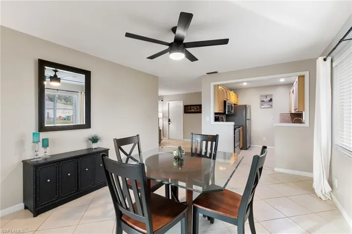 Dining area featuring light tile patterned flooring and ceiling fan