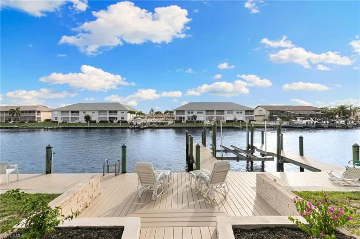 Dock area featuring a residential view, a water view, and boat lift