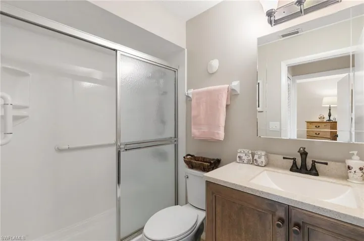 Full bath with vanity and a shower stall