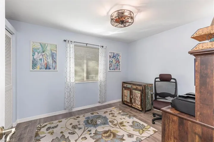 Office space featuring wood finished floors and baseboards