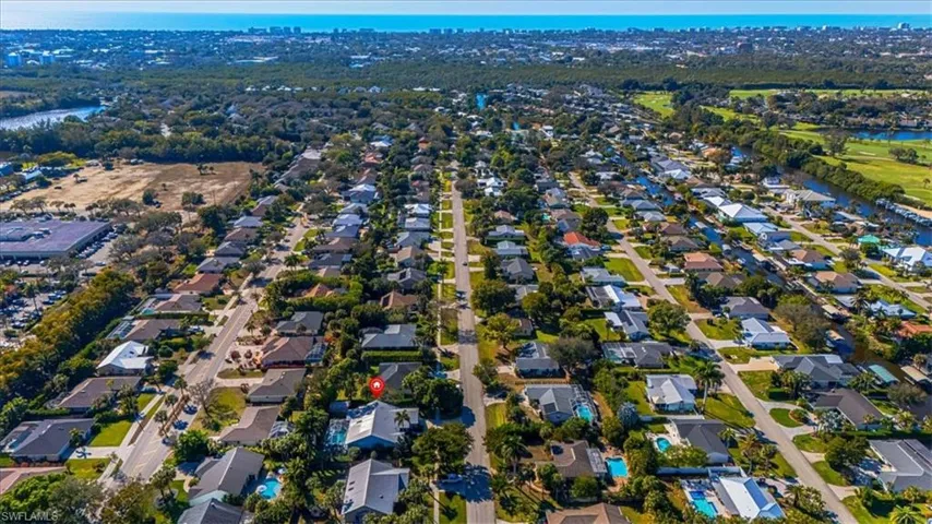 Aerial overview of property's location featuring nearby suburban area and a nearby body of water