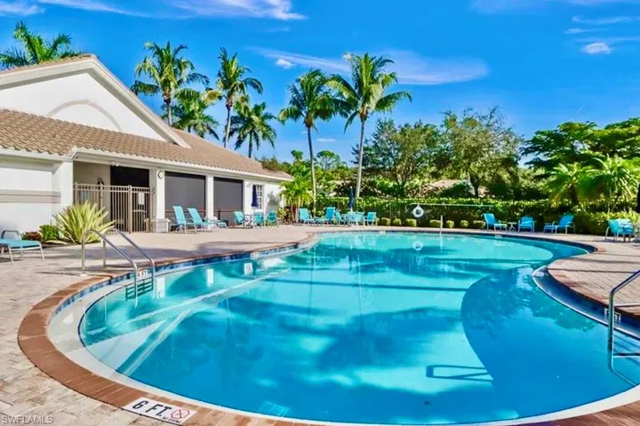 Community pool with fence and a patio area