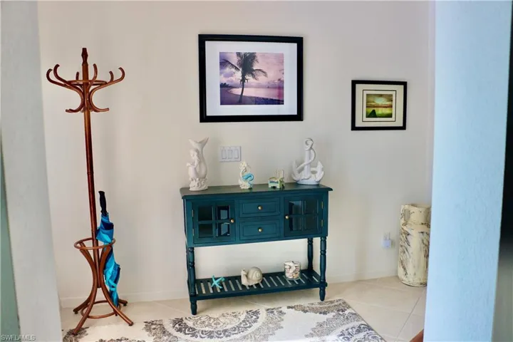 Hallway with light tile patterned floors