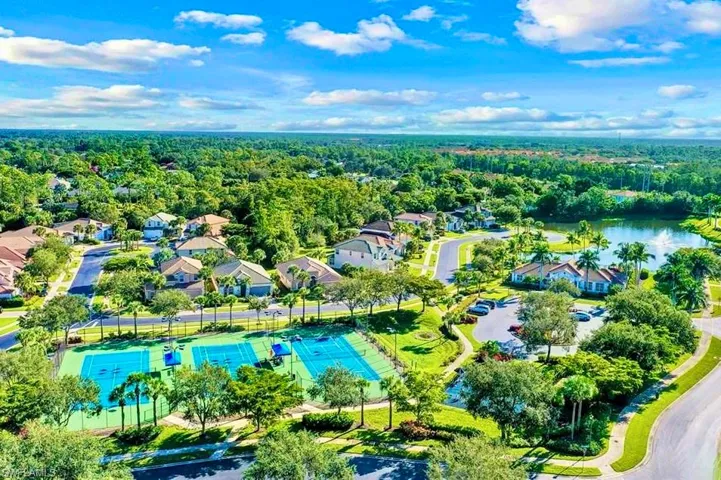 Drone / aerial view with a forest view, a residential view, and a water view