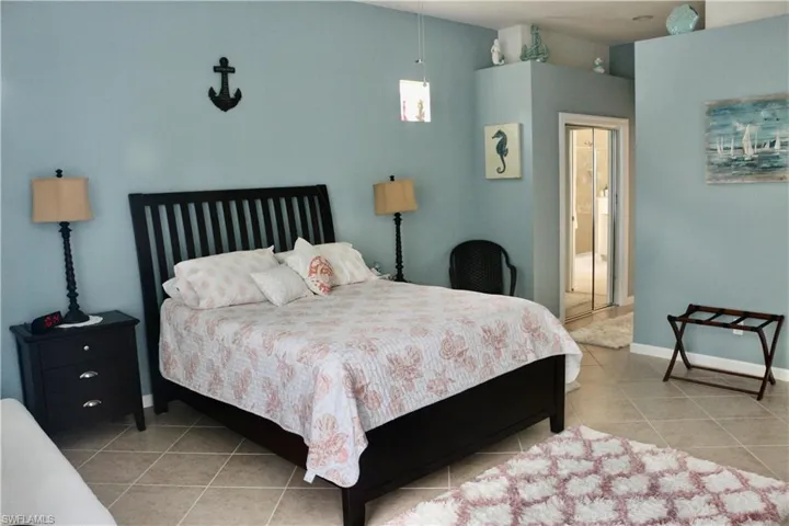 Bedroom with baseboards and tile patterned floors