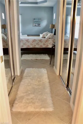 Hallway featuring light tile patterned floors