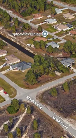 Aerial view of property's location with nearby suburban area