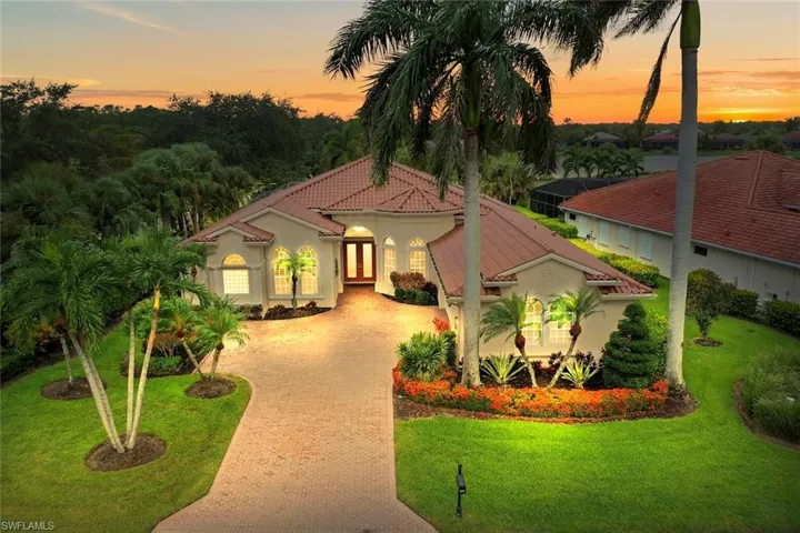 Naples Lakes Single Family Estate home with a new roof, 3 car garage, stucco exterior and a paved driveway