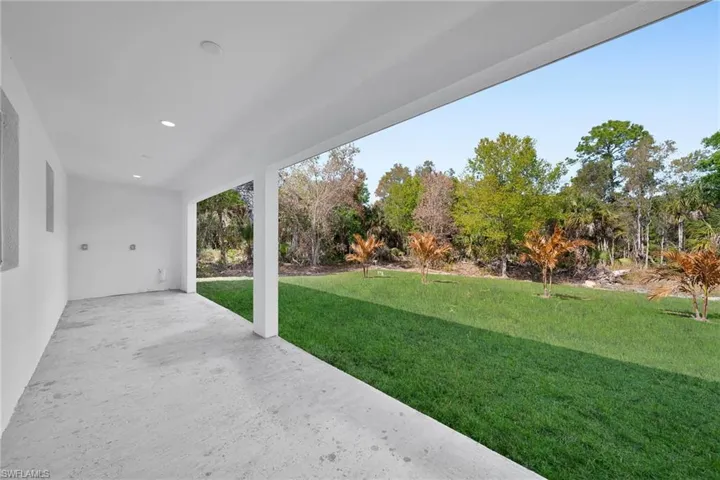 View of green lawn featuring a patio area