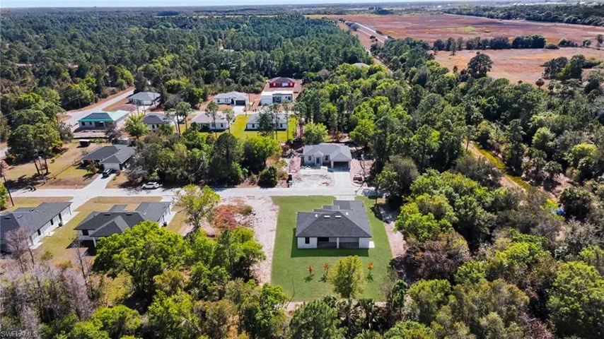 Aerial view of residential area with a heavily wooded area