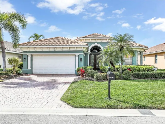 Mediterranean / spanish house with a garage and a front yard