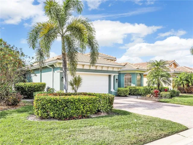 Mediterranean / spanish-style home featuring a garage and a front lawn