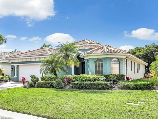 Mediterranean / spanish-style house with a garage and a front yard