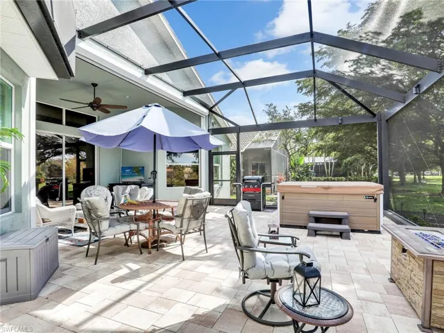 View of patio / terrace with a hot tub, a lanai, and ceiling fan