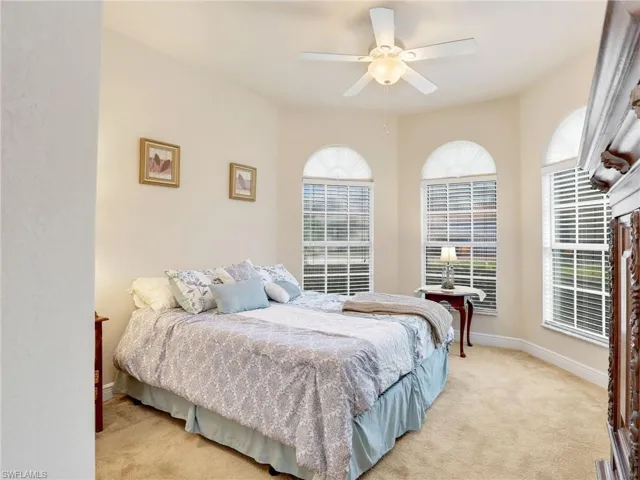 Carpeted bedroom with ceiling fan