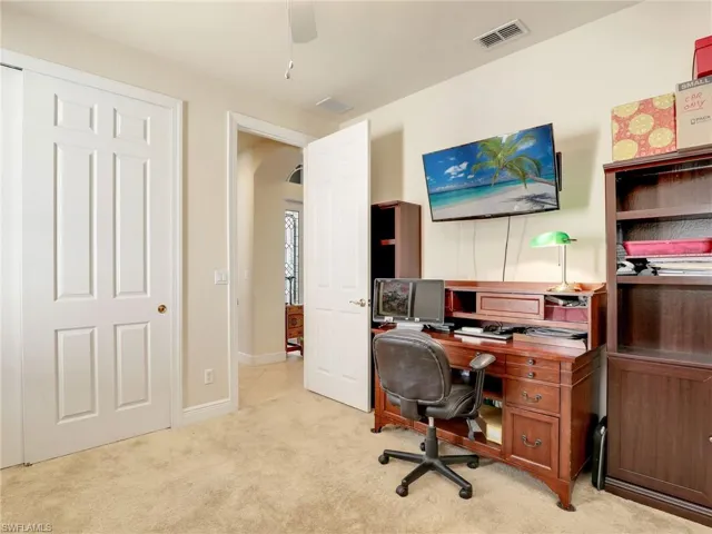 Home office with light colored carpet