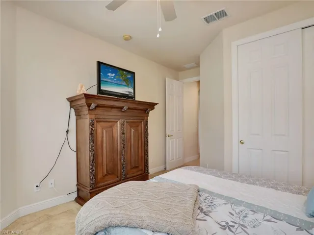 Carpeted bedroom featuring ceiling fan