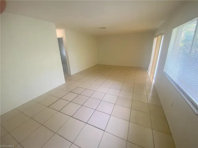 Unfurnished room with light tile patterned floors