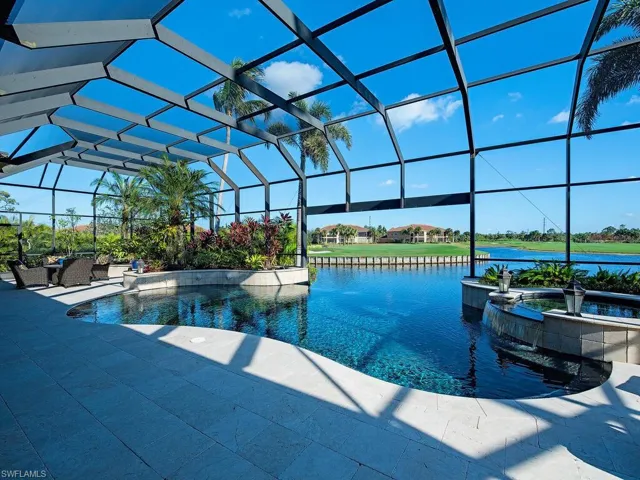 Pool and hot tub with open views of lake and golf course
