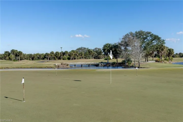 View of home's community featuring golf course view, view of wooded area, and a water view
